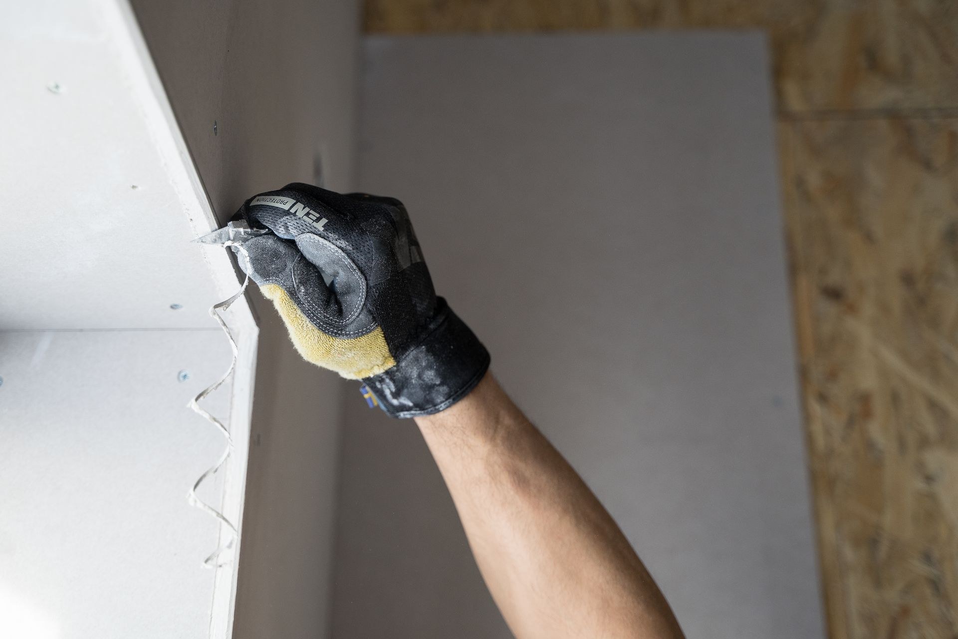 Applying plaster to make good a damaged wall surface