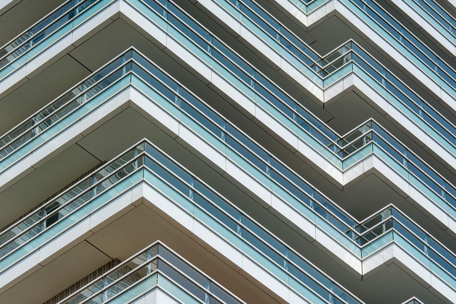 Glass balcony railings on a modern apartment building facade