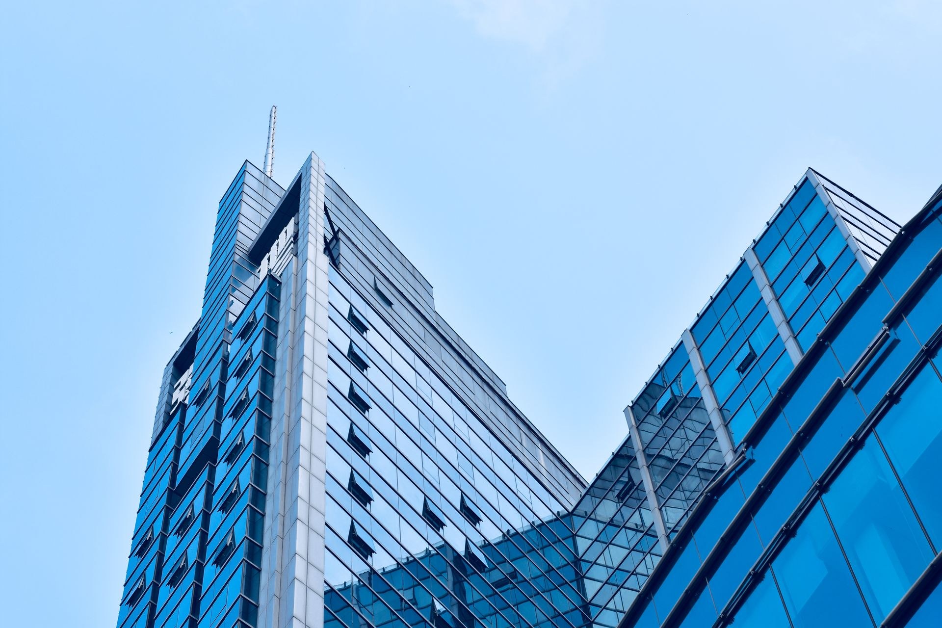 Low angle view of a contemporary Dubai commercial tower maintained by Velion