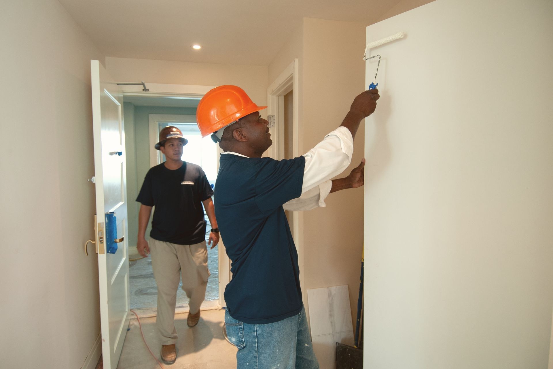 Painting team renovating interior walls of a commercial unit