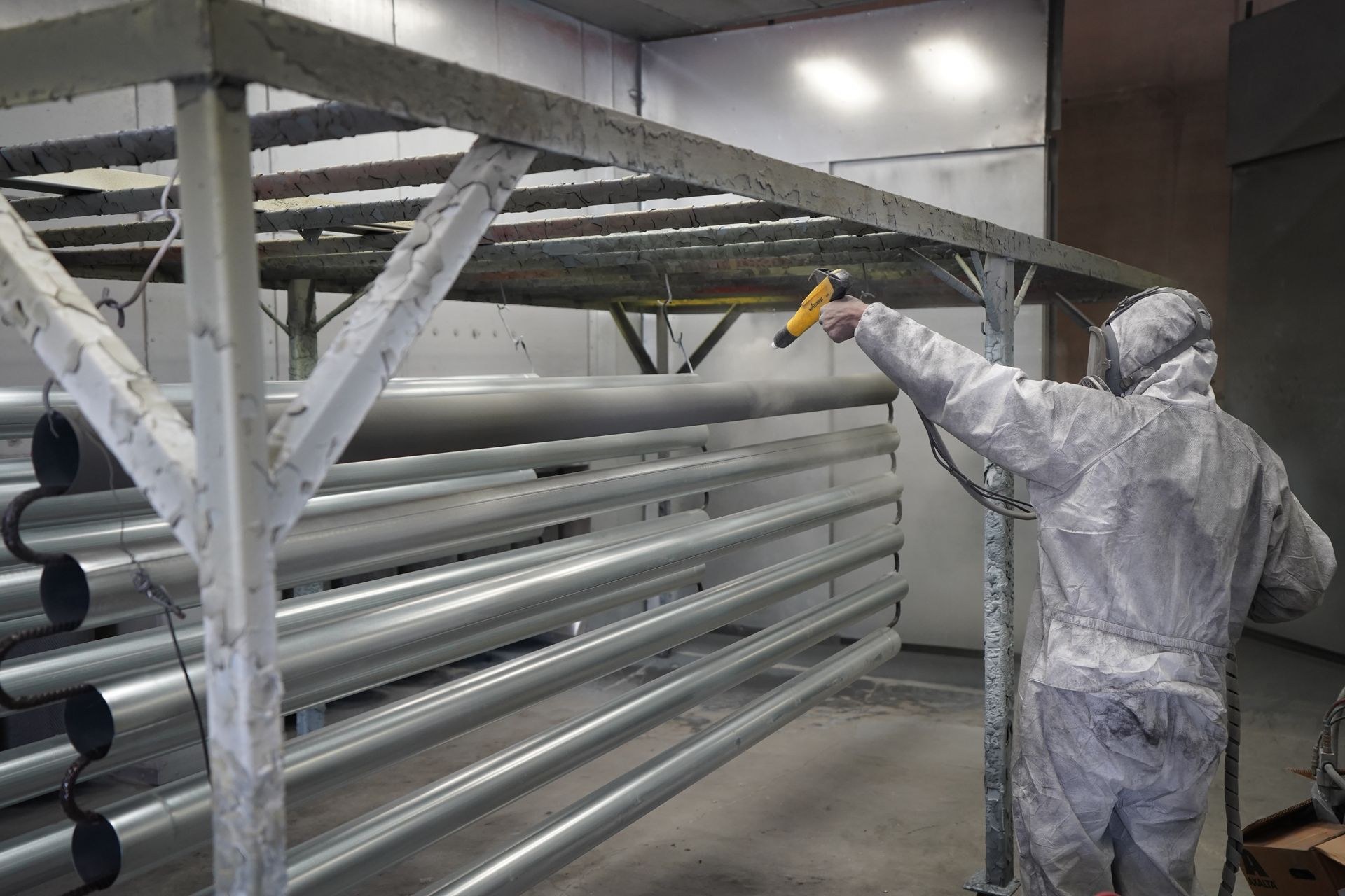 Protective coating being applied to metal components in a workshop