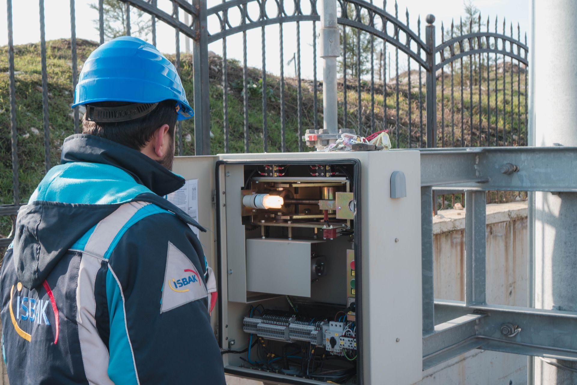 Technician installing and maintaining electrical equipment on a building roof